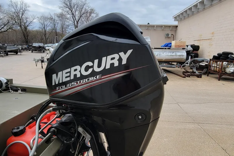 Slide: The Image of 2017 Tracker Grizzly 1648 SC with Mercury FourStroke engine in outdoor setting. - 19