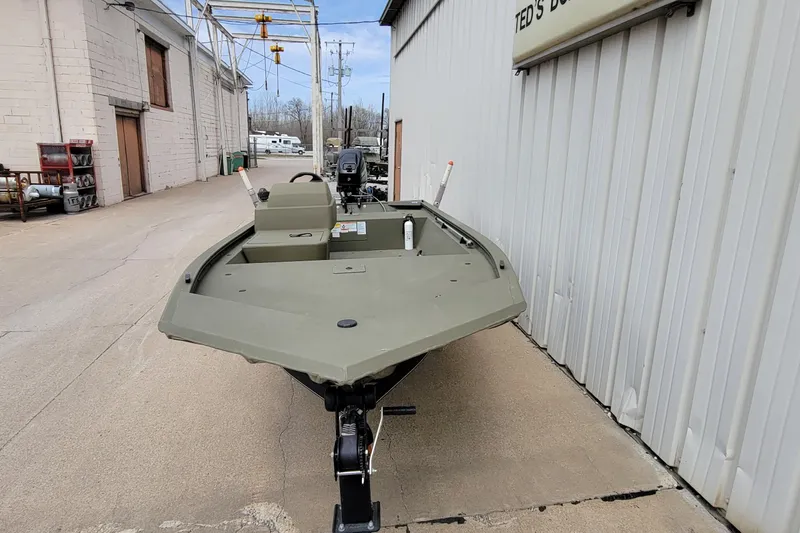 Slide: The Image of 2017 Tracker Grizzly 1648 SC boat parked outside a building on a trailer. - 3