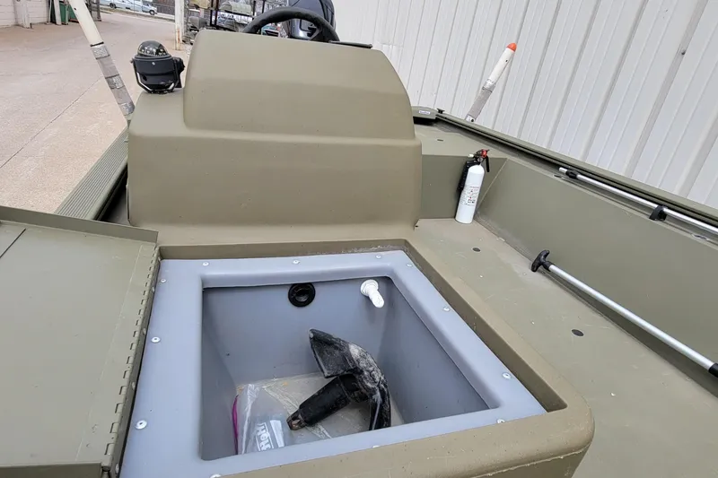 Slide: The Image of 2017 Tracker Grizzly 1648 SC boat interior with storage compartment and safety equipment. - 6