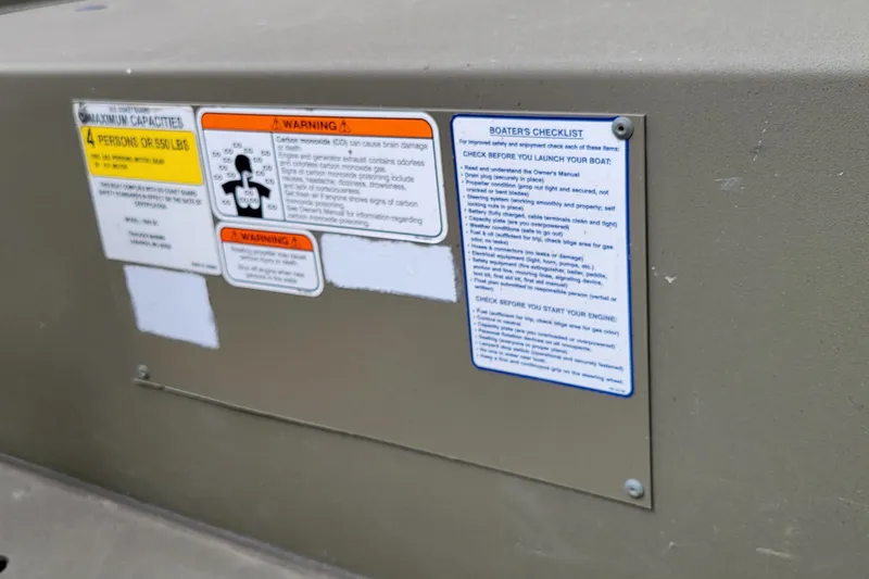Slide: The Image of Safety and capacity labels on a 2017 Tracker Grizzly 1648 SC boat. - 8