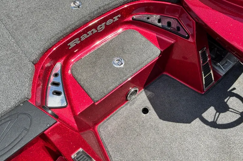 Slide: The Image of 2021 Ranger Z520C Cup-Equipped boat interior with red accents and carpeted flooring. - 10