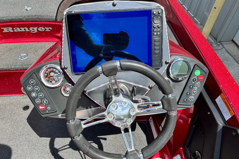 Slide: The Image of 2021 Ranger Z520C Cup-Equipped boat dashboard with steering wheel and control panel. - 12