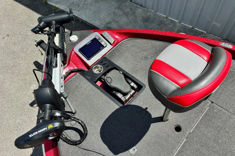 Slide: The Image of 2021 Ranger Z520C Cup-Equipped boat interior with red seat and control panel. - 6