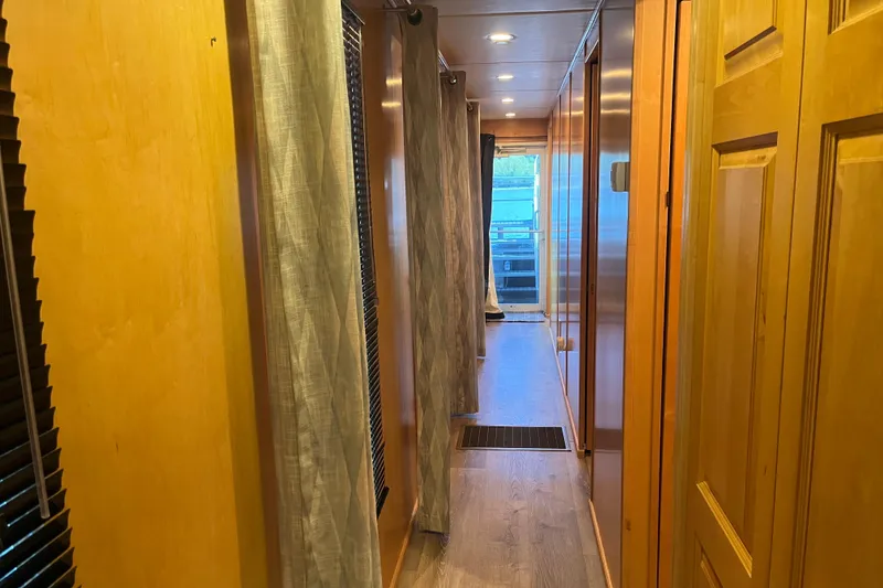 Slide: The Image of Hallway inside 2005 Majestic Legacy RV, featuring wooden paneling and curtains. - 21