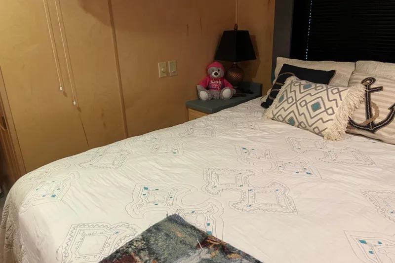 Slide: The Image of Cozy bedroom in 2005 Majestic Legacy RV with decorative pillows and teddy bear. - 25