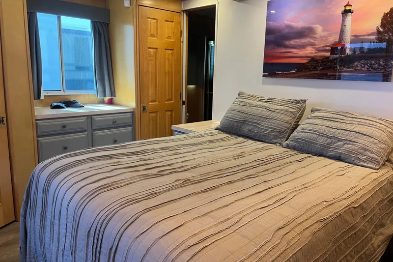 Slide: The Image of Cozy bedroom in 2005 Majestic Legacy RV with lighthouse artwork. - 28