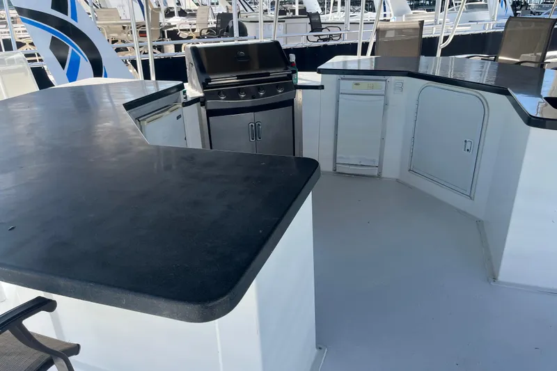 Slide: The Image of Outdoor kitchen on 2005 Majestic Legacy boat with grill and counter space. - 37