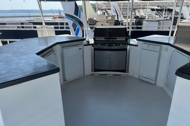 Slide: The Image of Outdoor kitchen on a 2005 Majestic Legacy boat with grill and appliances. - 38