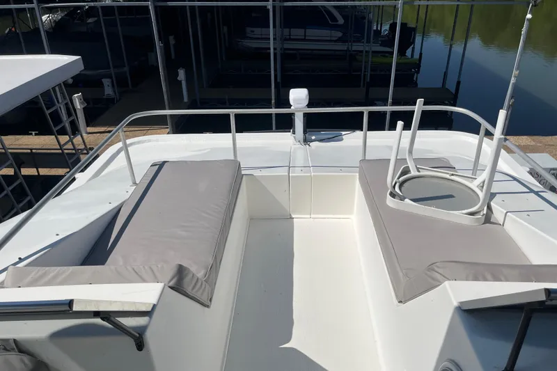 Slide: The Image of Rooftop deck of a 2005 Majestic Legacy boat with cushioned seating. - 44