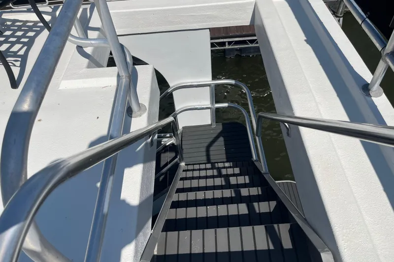 Slide: The Image of Staircase on a 2005 Majestic Legacy boat, featuring sleek metal railings. - 46