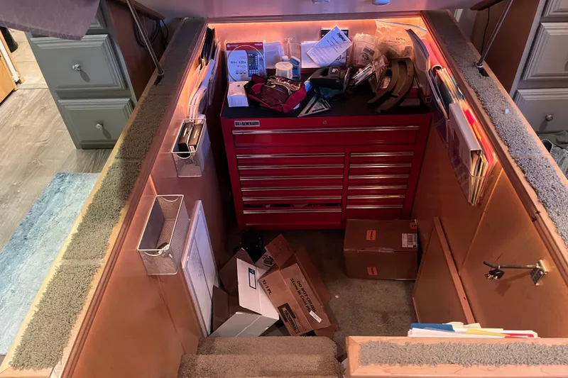 Slide: The Image of Carpeted stairs leading to a basement with a red tool chest and various items. - 53