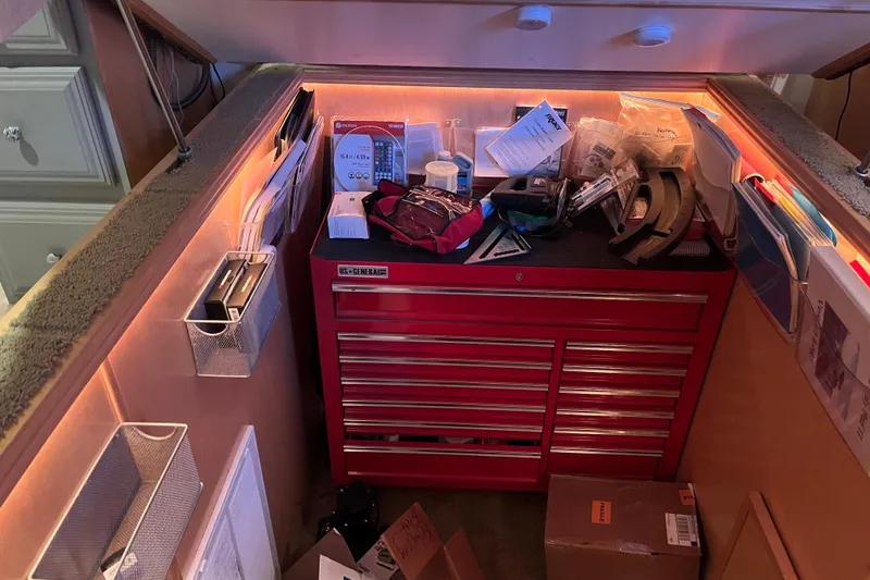 Slide: The Image of Red tool chest in a well-organized workspace, featuring various tools and documents. - 54