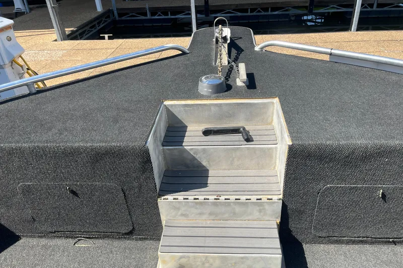 Slide: The Image of Bow of a 2005 Majestic Legacy boat with steps and anchor chain. - 7