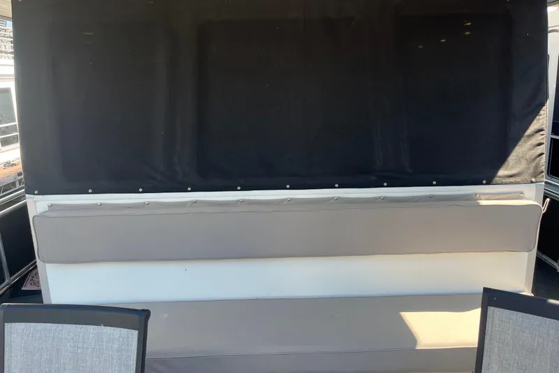 Slide: The Image of Interior seating of a 2005 Majestic Legacy boat with black and gray upholstery. - 8