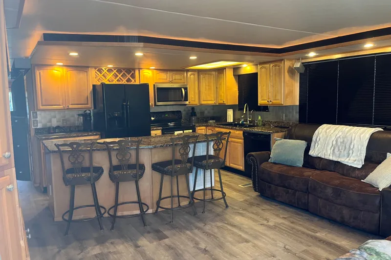 Slide: The Image of Luxurious 2005 Majestic Legacy RV interior with modern kitchen and cozy seating area. - 9