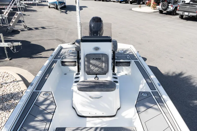 Slide: The Image of 2026 Avid 207 Recon boat, sleek design, spacious seating, parked in a sunny lot. - 12