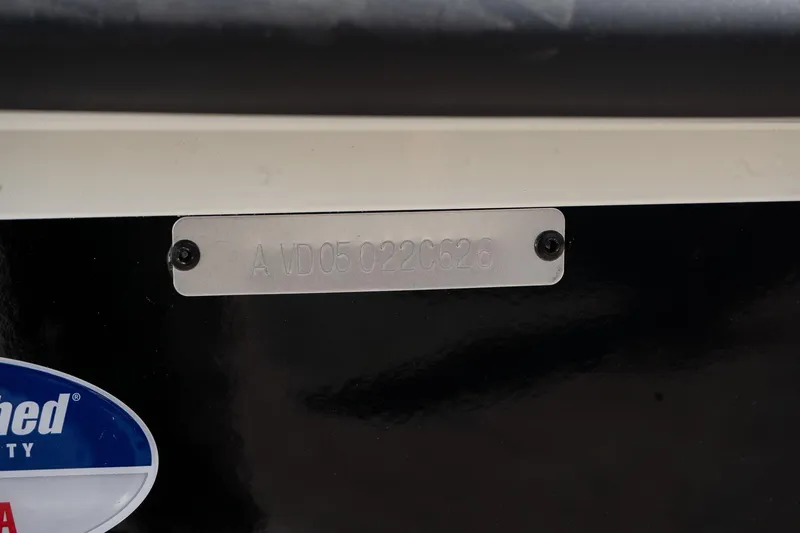 Slide: The Image of Serial number plate on 2026 Avid 207 Recon boat, featuring engraved identification code. - 15
