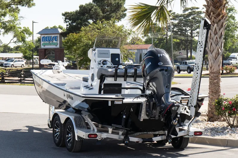 Slide: The Image of Avid 207 Recon 2026 boat on trailer, parked near Neuse Sport Shop. - 4