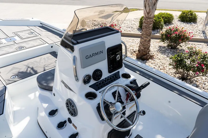 Slide: The Image of Avid 207 Recon 2026 boat console with Garmin navigation, steering wheel, and control panel. - 8