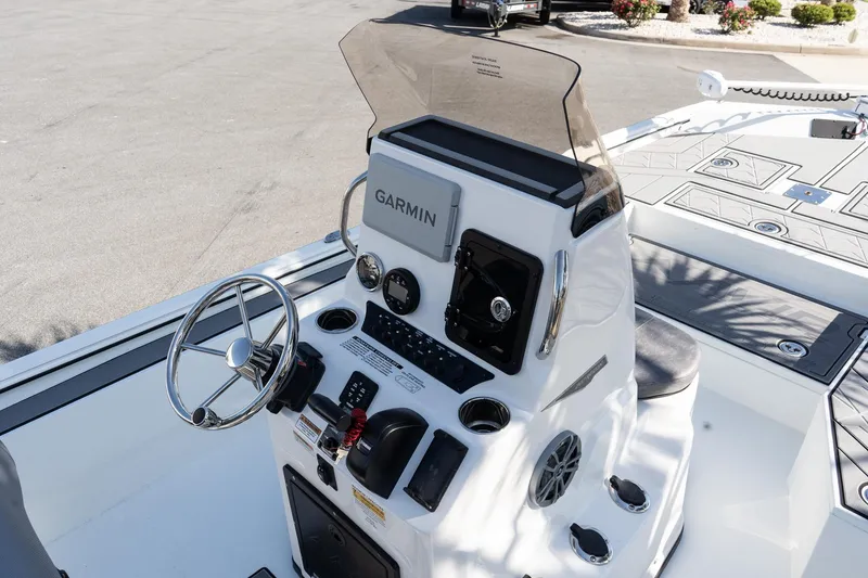 Slide: The Image of Avid 207 Recon 2026 boat console with Garmin navigation system and steering wheel. - 9