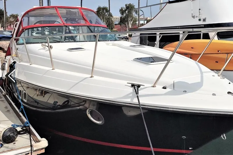 The Image of 2019 Rinker EX 370 boat docked, featuring sleek design and red canopy. - 0