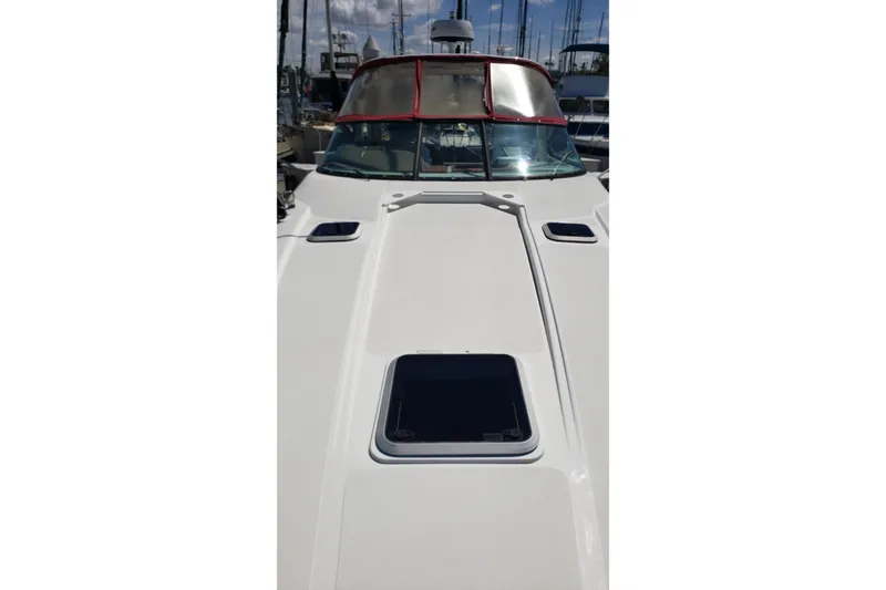 Slide: The Image of 2019 Rinker EX 370 boat deck with hatches, docked at marina. - 12