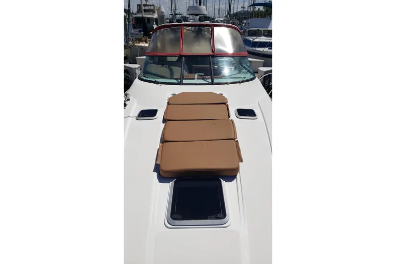 Slide: The Image of 2019 Rinker EX 370 boat with sun pads on deck, docked at marina. - 13