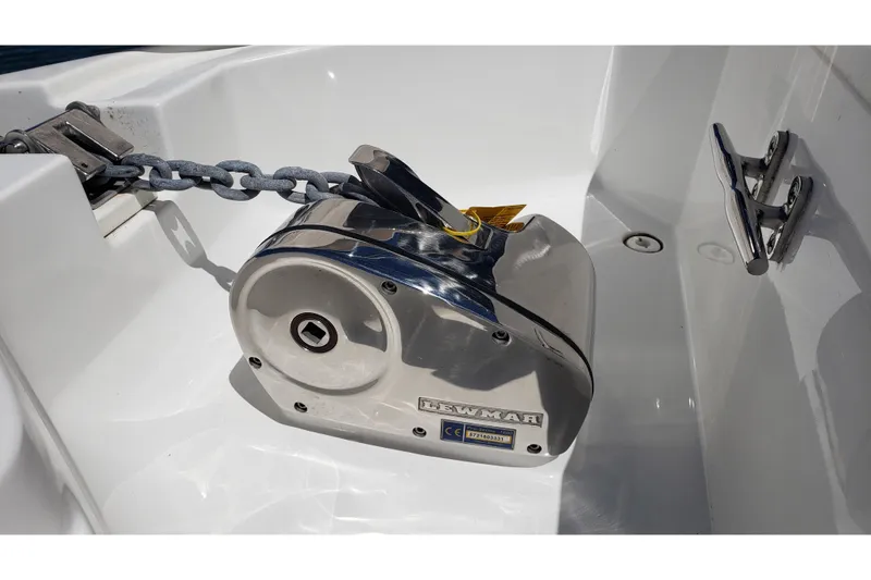 Slide: The Image of Anchor windlass on 2019 Rinker EX 370 boat deck, featuring a sturdy chain. - 18