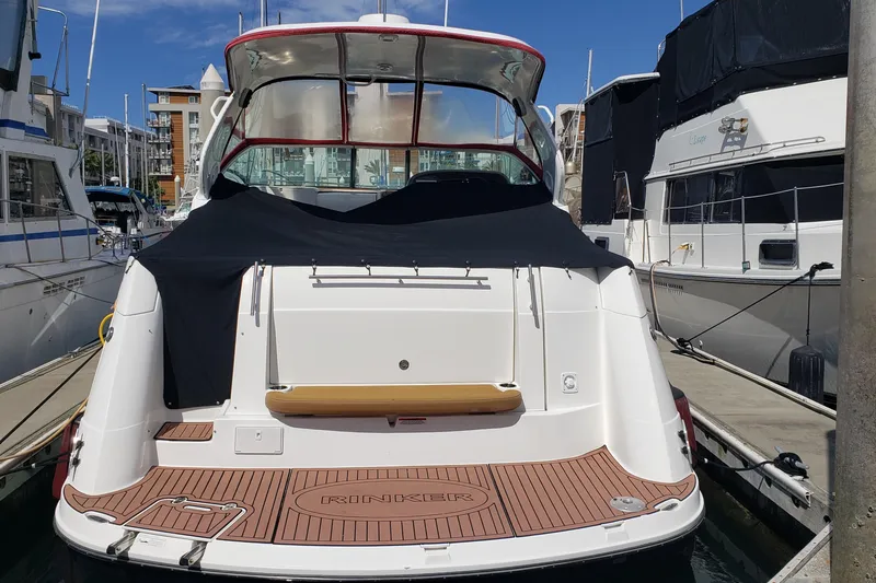 Slide: The Image of 2019 Rinker EX 370 yacht docked at marina, rear view with covered deck. - 2