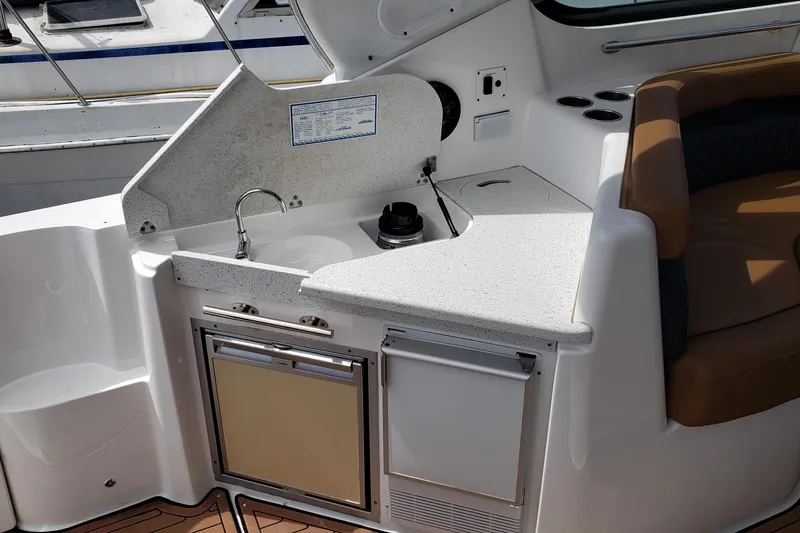 Slide: The Image of 2019 Rinker EX 370 boat kitchenette with sink and refrigerator. - 21