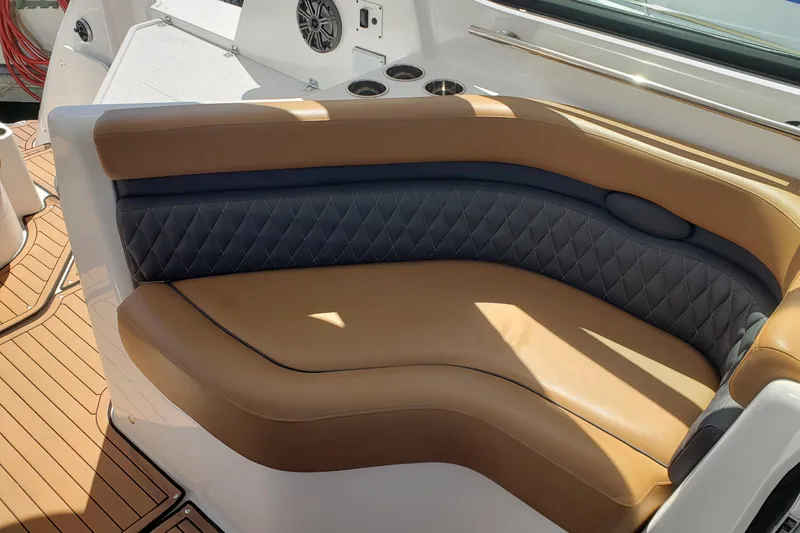 Slide: The Image of 2019 Rinker EX 370 boat interior with tan and black leather seating. - 22
