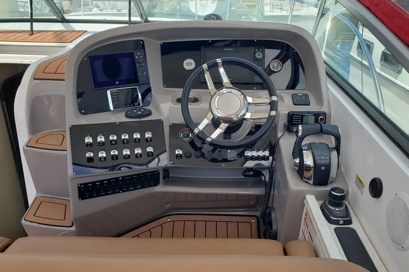 Slide: The Image of 2019 Rinker EX 370 helm with modern controls and navigation equipment. - 26