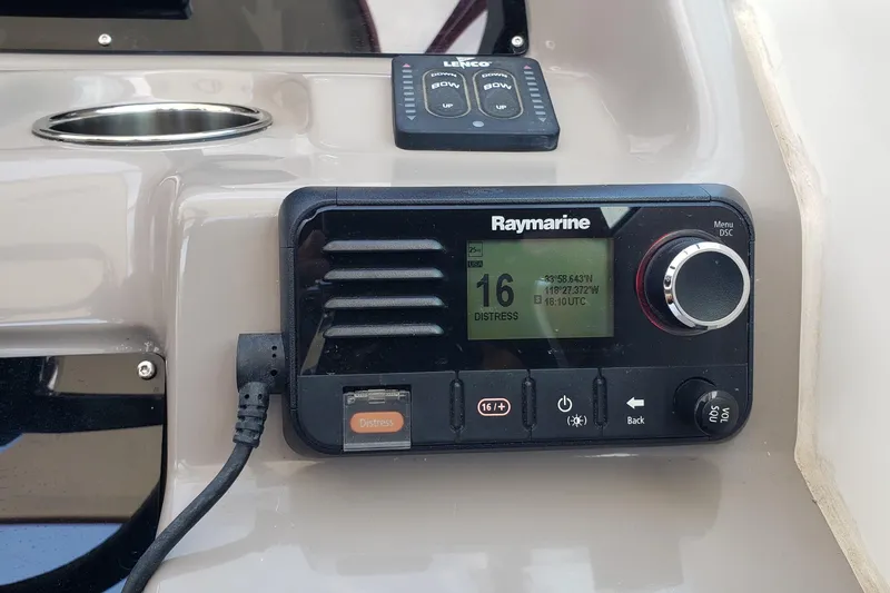 Slide: The Image of Raymarine marine radio on 2019 Rinker EX 370 boat dashboard, displaying distress channel. - 32