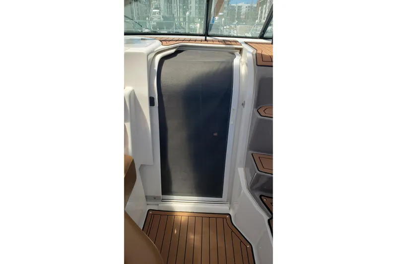 Slide: The Image of 2019 Rinker EX 370 cabin entrance with sleek design and wood-textured flooring. - 33