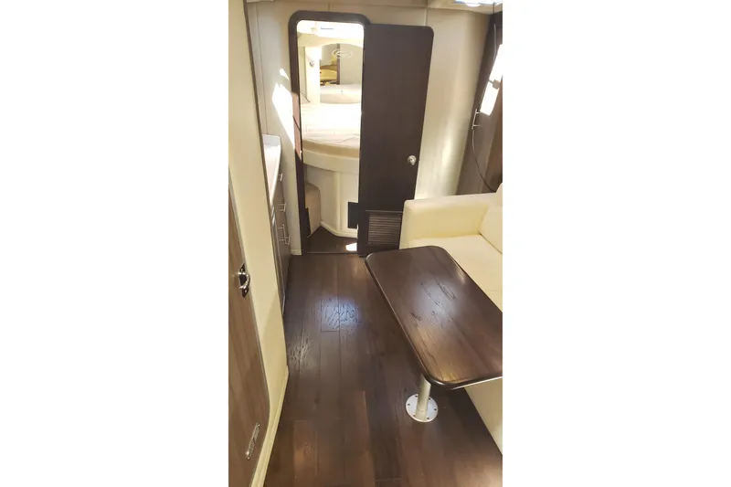 Slide: The Image of Interior of 2019 Rinker EX 370 yacht with wooden flooring and cozy seating area. - 34
