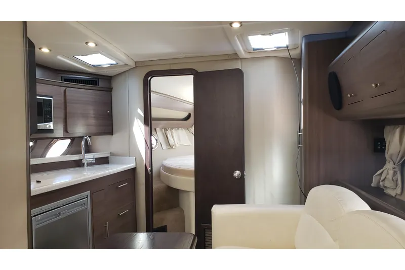Slide: The Image of 2019 Rinker EX 370 yacht interior with modern kitchen and cozy seating area. - 36