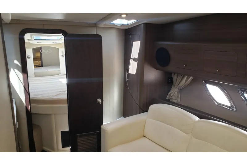 Slide: The Image of Interior of 2019 Rinker EX 370 yacht with cozy seating and elegant wood finishes. - 37