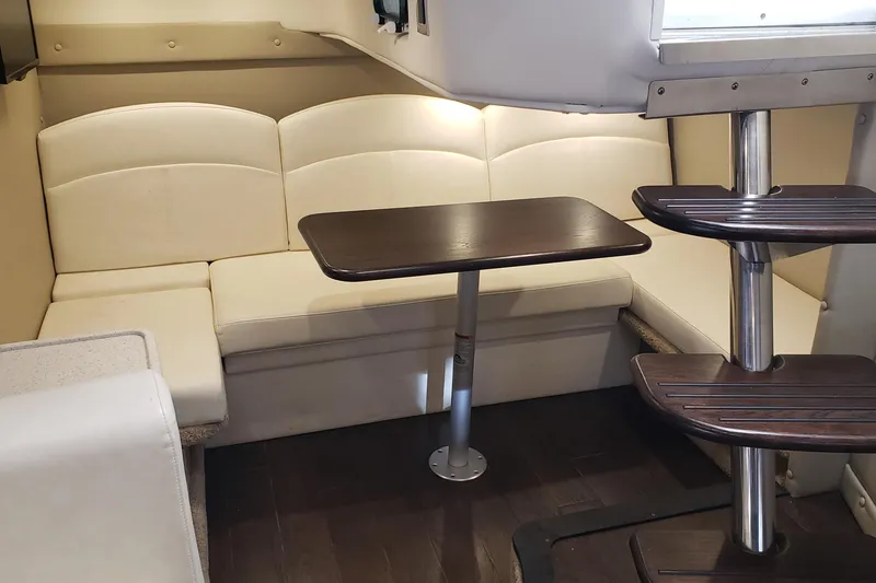 Slide: The Image of Interior of 2019 Rinker EX 370 yacht with beige seating and wooden table. - 38