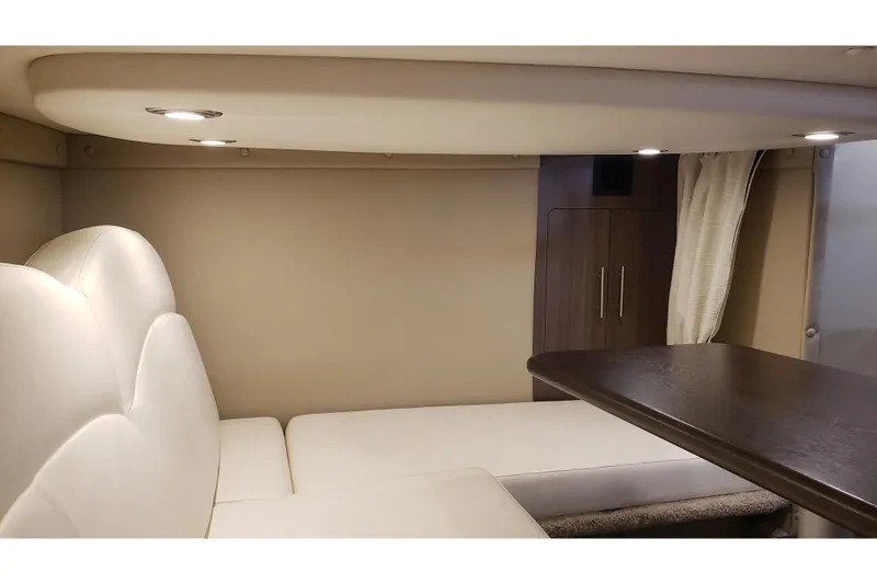 Slide: The Image of Interior of 2019 Rinker EX 370 yacht with white seating and wooden table. - 41
