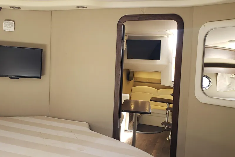 Slide: The Image of Interior of 2019 Rinker EX 370 yacht with TV, seating, and table. - 54