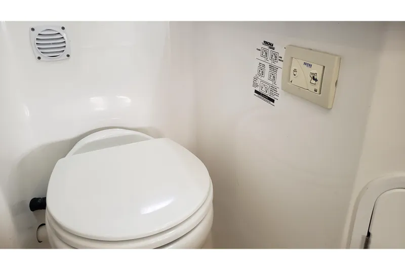 Slide: The Image of 2019 Rinker EX 370 boat bathroom with toilet and control panel. - 55