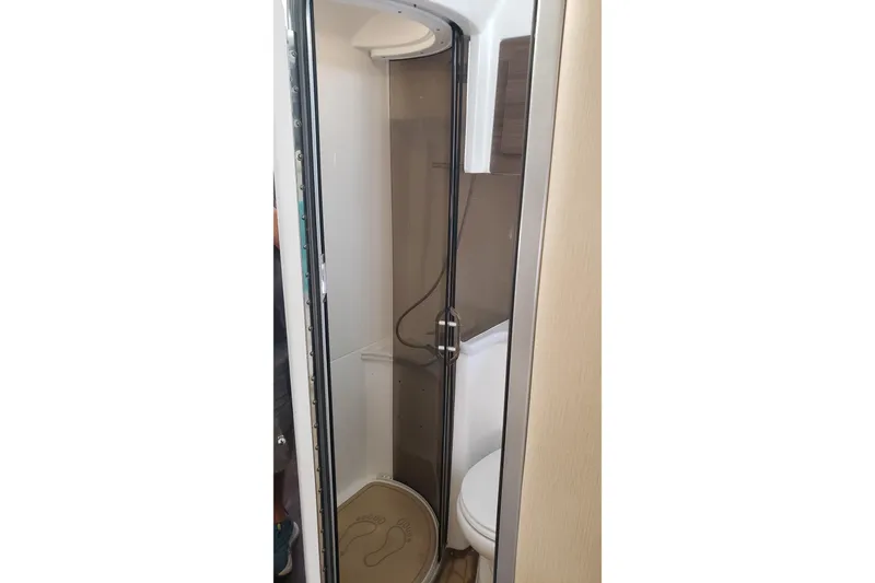 Slide: The Image of 2019 Rinker EX 370 bathroom with shower and toilet, featuring modern design and compact space. - 57