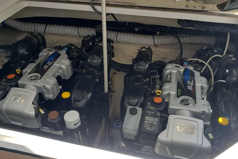 Slide: The Image of Twin MerCruiser engines in a 2019 Rinker EX 370 boat engine compartment. - 61