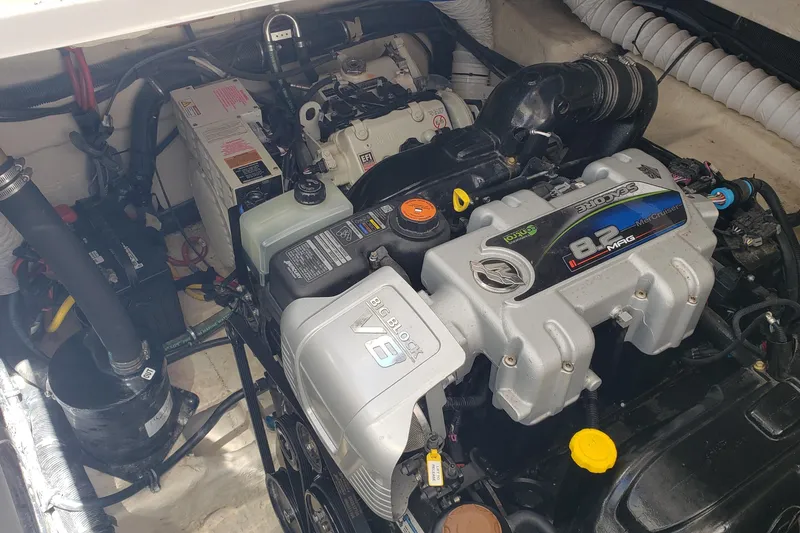 Slide: The Image of Engine compartment of a 2019 Rinker EX 370 boat featuring a MerCruiser 8.2 MAG engine. - 62