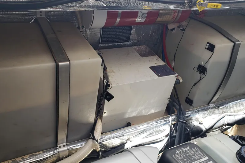 Slide: The Image of 2019 Rinker EX 370 engine compartment with equipment and wiring. - 65
