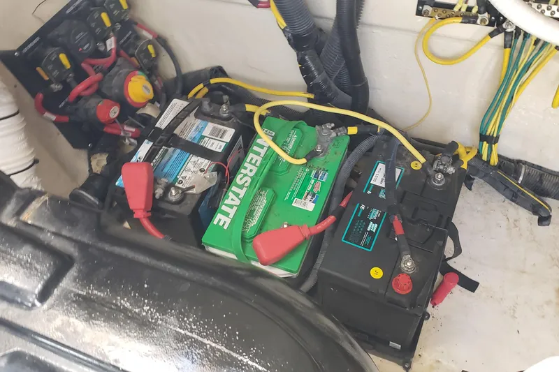 Slide: The Image of Battery compartment of a 2019 Rinker EX 370 boat with wiring and connections. - 66