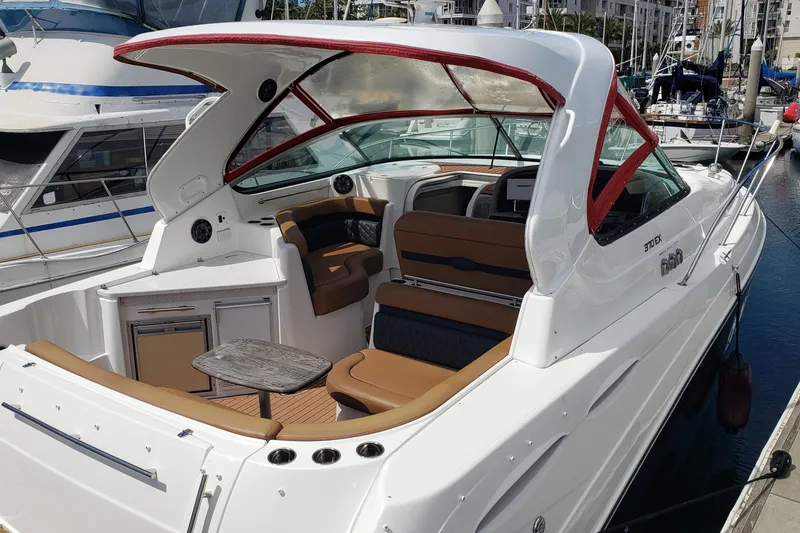Slide: The Image of 2019 Rinker EX 370 boat with spacious seating and modern design docked at marina. - 7