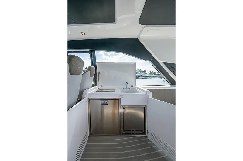 Slide: The Image of Interior view of 2019 Azimut Atlantis 51 yacht featuring a sleek kitchenette area. - 23