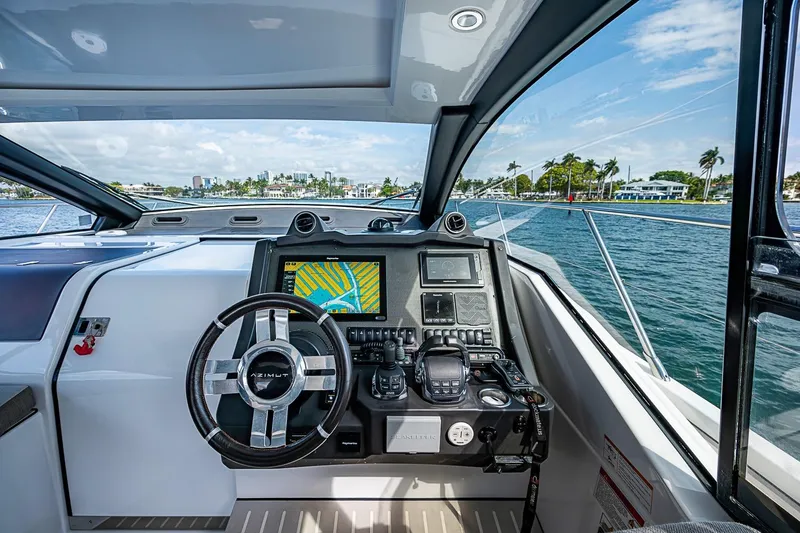 Slide: The Image of Cockpit view of 2019 Azimut Atlantis 51 yacht with navigation system and steering wheel. - 28