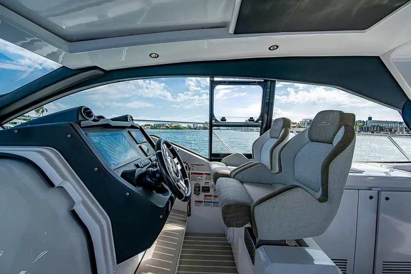 Slide: The Image of Interior view of 2019 Azimut Atlantis 51 yacht cockpit with dual seats and ocean backdrop. - 29